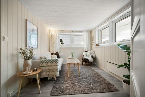 Cozy living room with a textured area rug, sofa, and coffee table