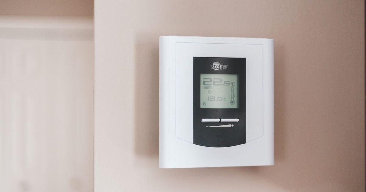 Digital thermostat mounted on a wall