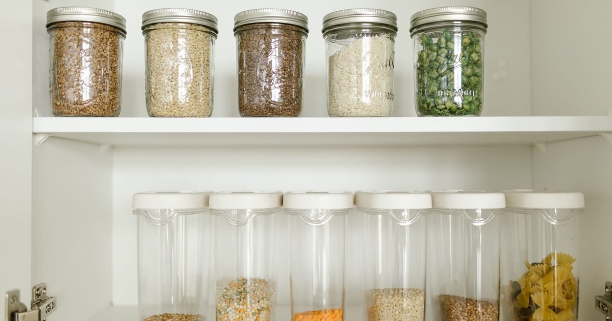 Organized pantry shelf with dry goods in glass jars