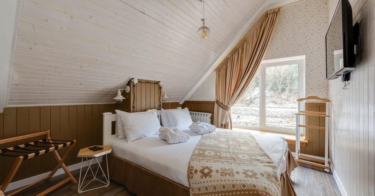 Bright bedroom with a made bed and pillows