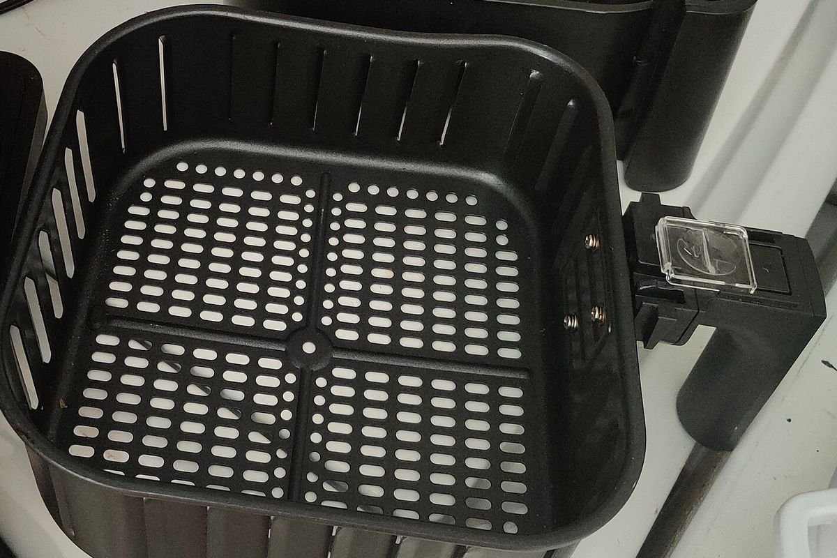 Square nonstick air fryer basket and crisper tray removed for cleaning