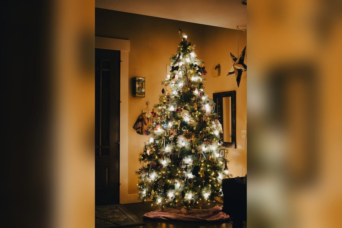 Christmas tree glowing with warm clear lights in a cozy living room (representative photo, not the exact product)