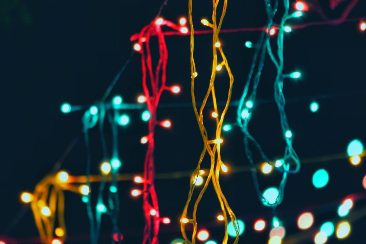 Strands of red, gold and teal mini LED string lights hanging against a dark background (representative photo, not the exact product)