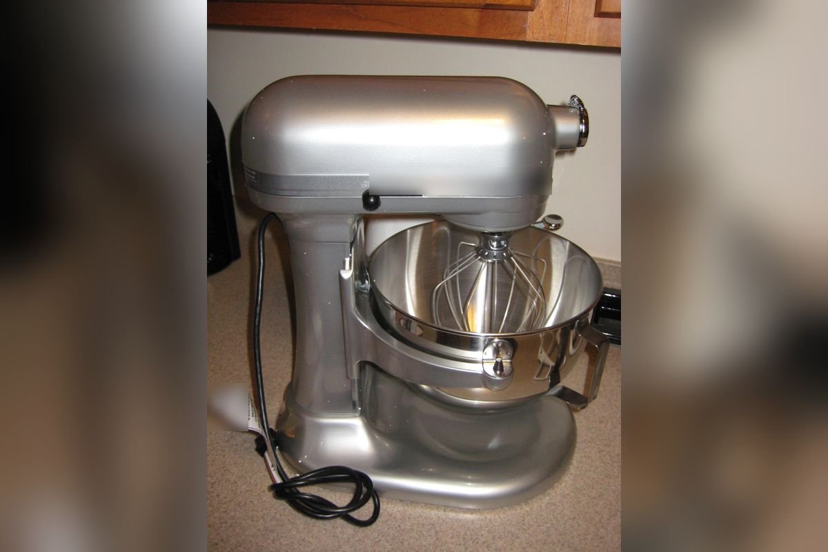 Silver bowl-lift stand mixer with a wire whisk in a large stainless bowl (representative photo, not the exact product)