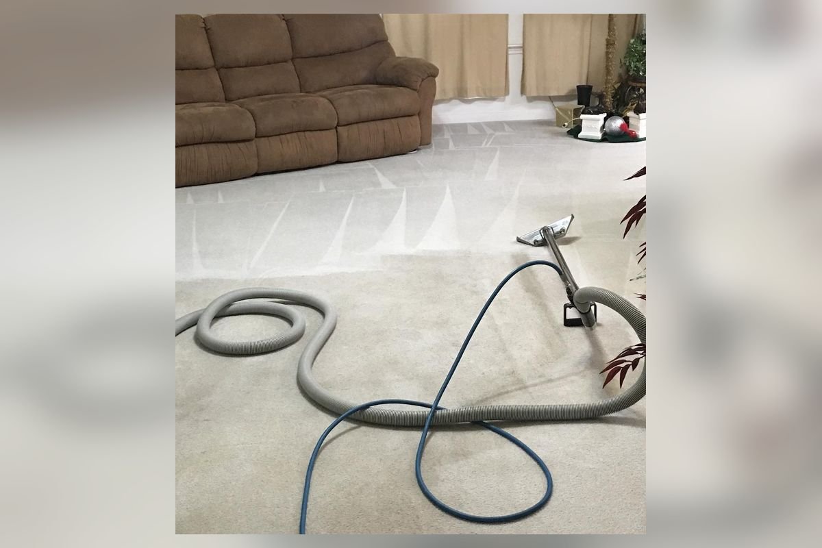 Freshly deep-cleaned beige carpet with a cleaning hose and wand (representative photo, not the exact product)