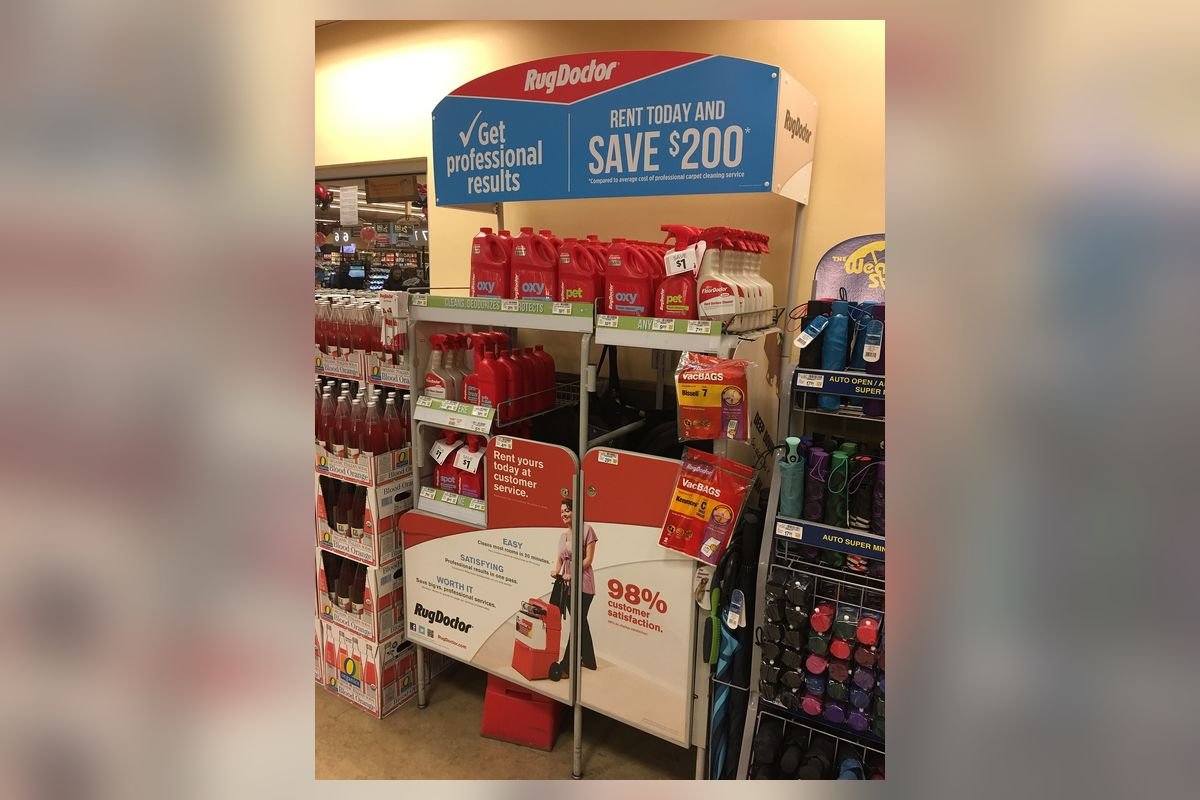 Store display of red upright carpet cleaning machines (representative photo, not the exact product)
