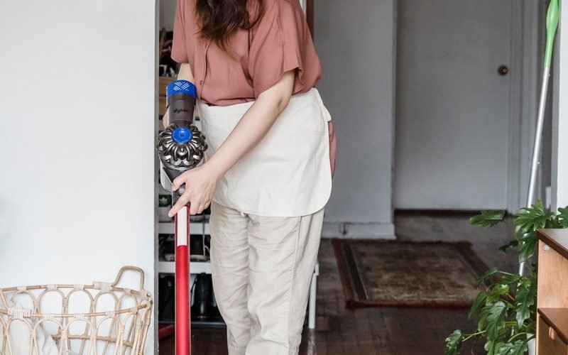 Woman cleaning a wooden floor at home