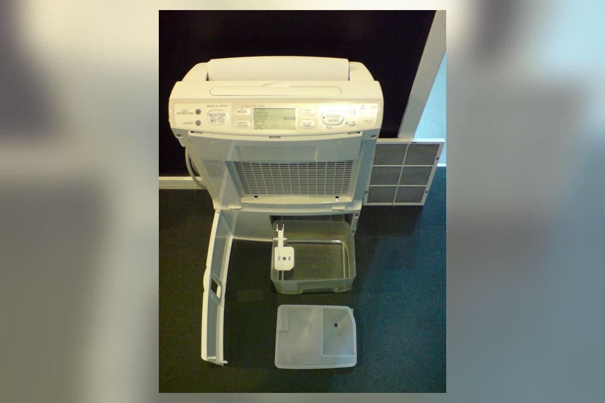 White dehumidifier with its water collection bucket pulled out (representative photo, not the exact product)