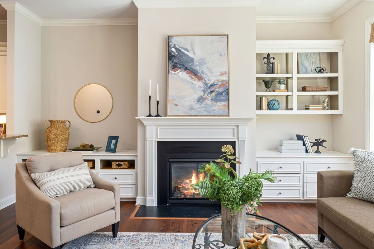 Cozy living room with a modern fireplace, armchair and built-in shelves (representative photo, not the exact product)