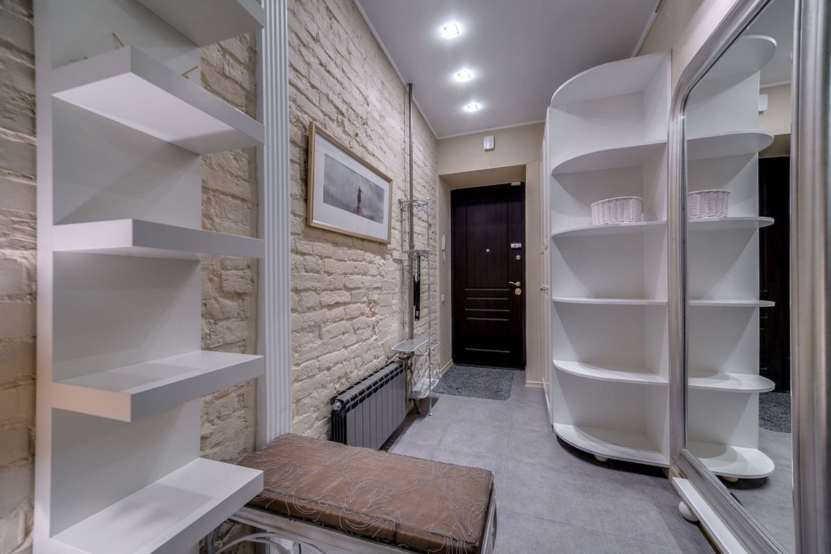 Modern entryway with white shelving and a cushioned bench (representative photo, not the exact product)