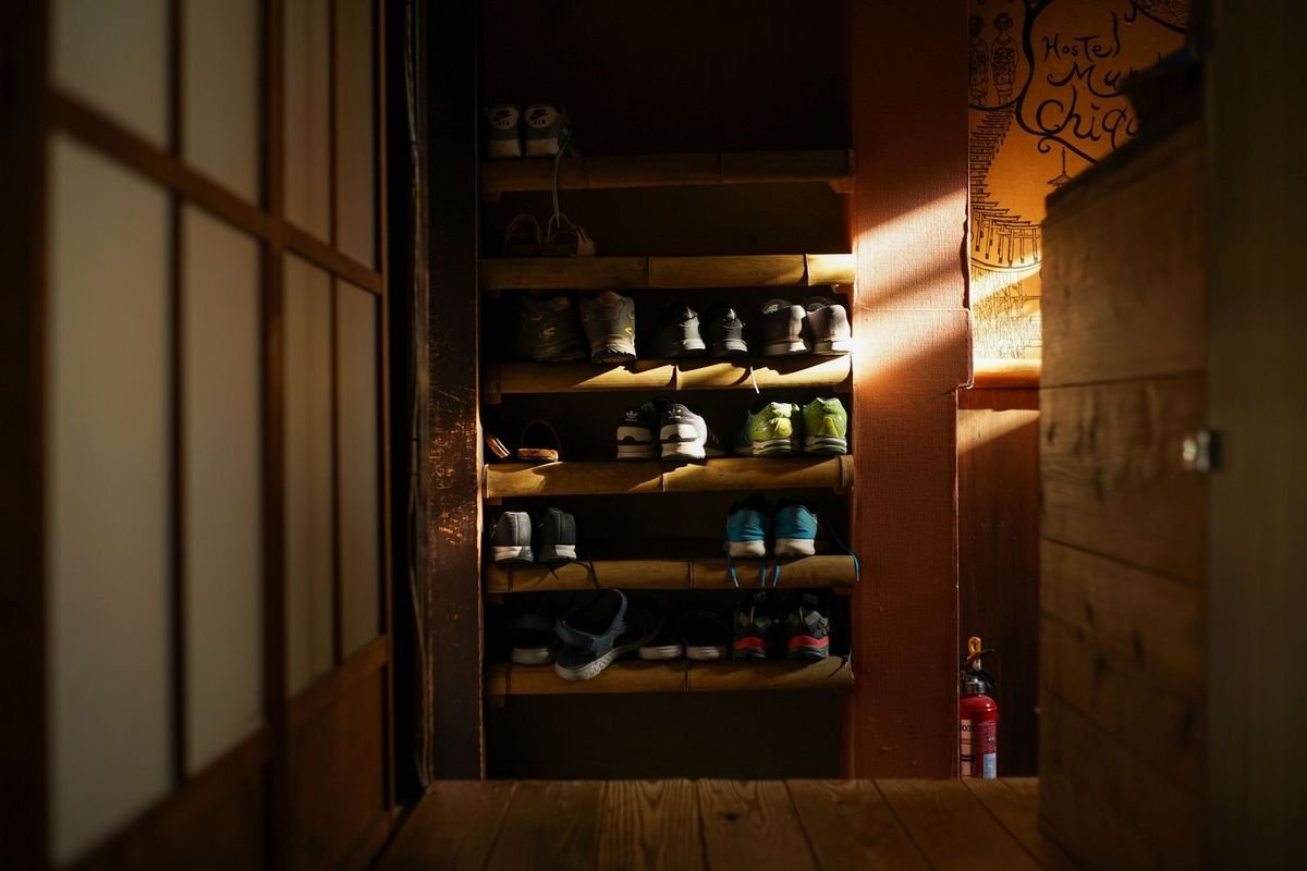 Sneakers lined up on a bamboo shoe rack (representative photo, not the exact product)