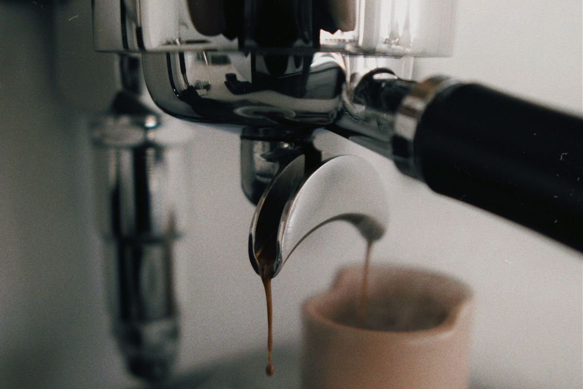Compact espresso machine brewing a shot into a cup in a modern kitchen (representative photo, not the exact product)