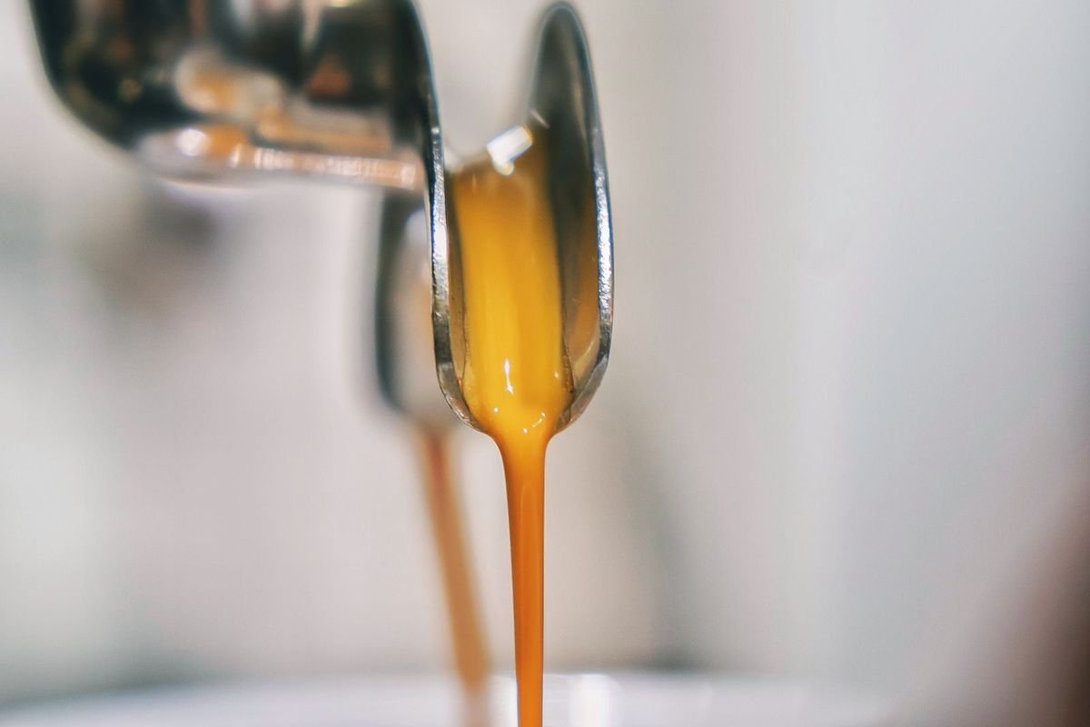 Close-up of espresso pouring from a machine into a white cup (representative photo, not the exact product)