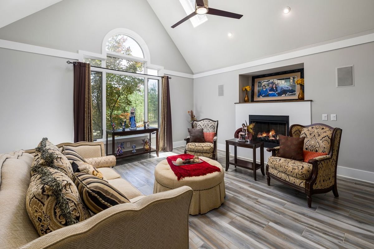 Bright, cozy living room with a fireplace and large windows