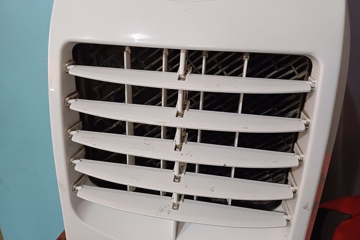Close-up of the louvered air outlet on a white portable air conditioner (representative photo, not the exact product)