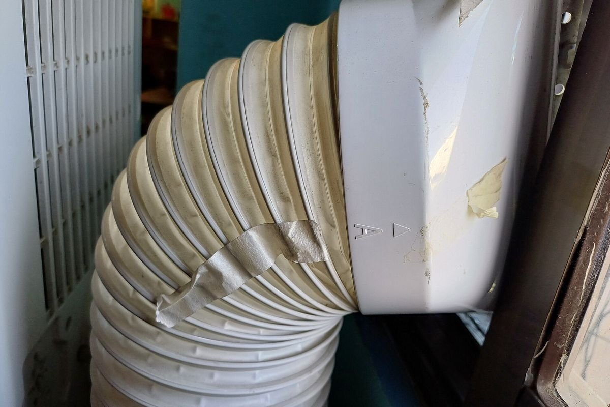 Close-up of a portable air conditioner exhaust hose connection (representative photo, not the exact product)