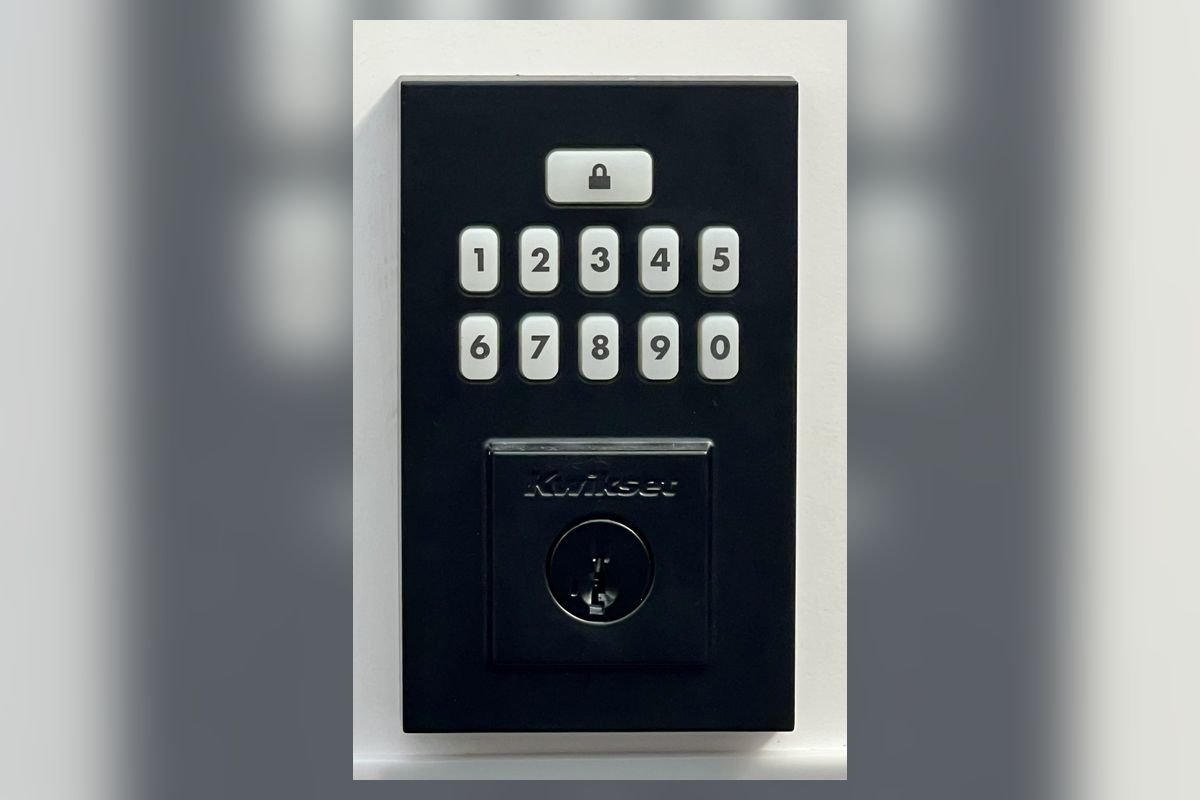 Black push-button keypad deadbolt on a door (representative photo, not the exact product)