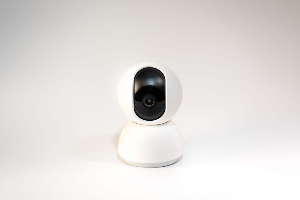 White smart home security camera on a white background (representative photo, not the exact product)